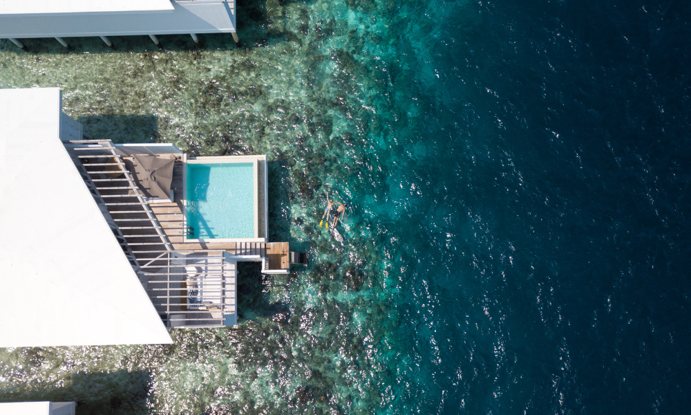 Amilla reef villas with snorkellers in water